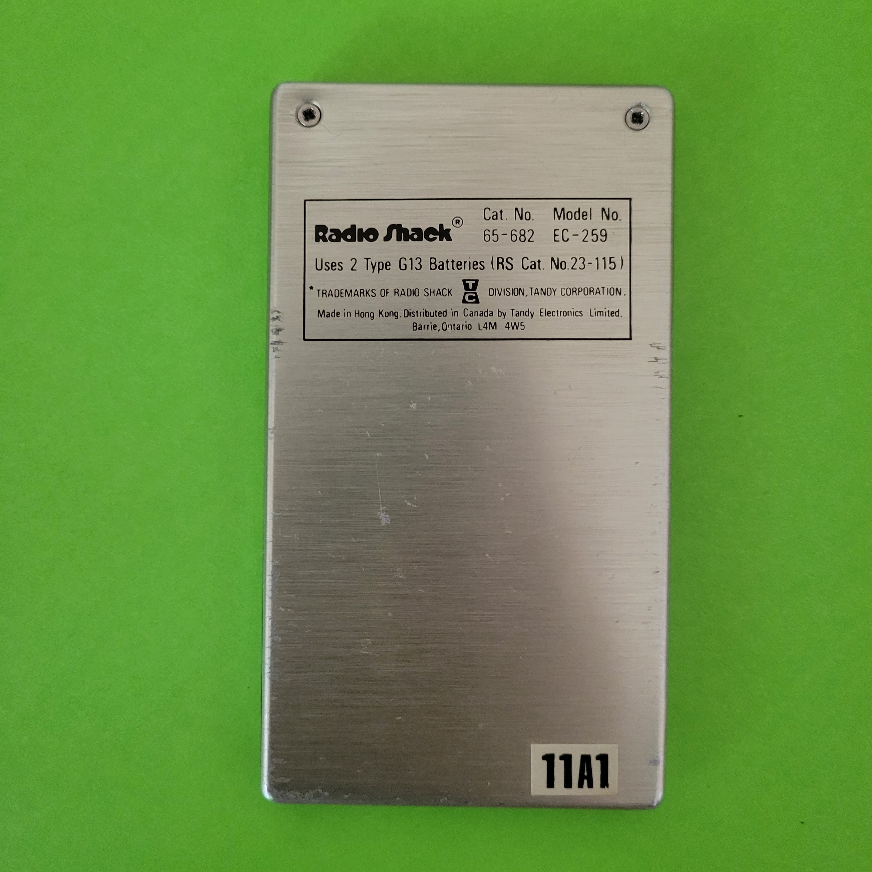 An image of the back of a Radio Shack Statesman thin LCD Four Function + calculator